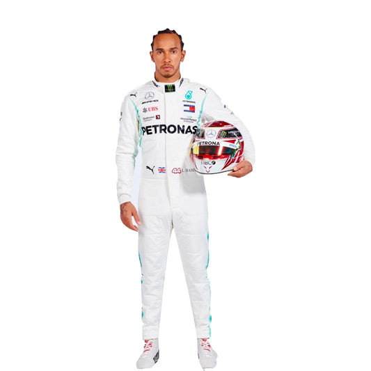 Person in a white racing suit holding a helmet with visible branding on a white background