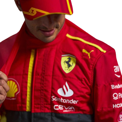 Person wearing a red racing suit with various logos on a white background