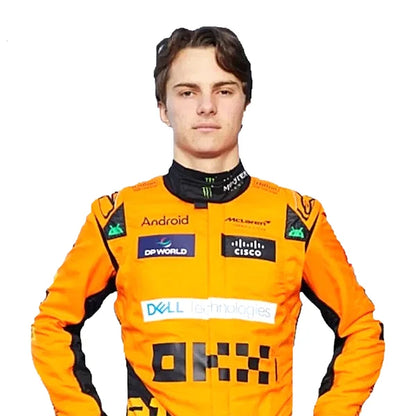 2024 Oscar Piastri McLaren F1 Racing Suit Kit featuring papaya orange and dark charcoal race suit, black and orange racing gloves, and low-profile driving shoes