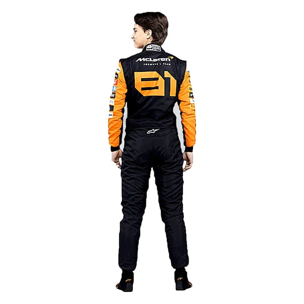 2024 Oscar Piastri McLaren F1 Racing Suit Kit featuring papaya orange and dark charcoal race suit, black and orange racing gloves, and low-profile driving shoes