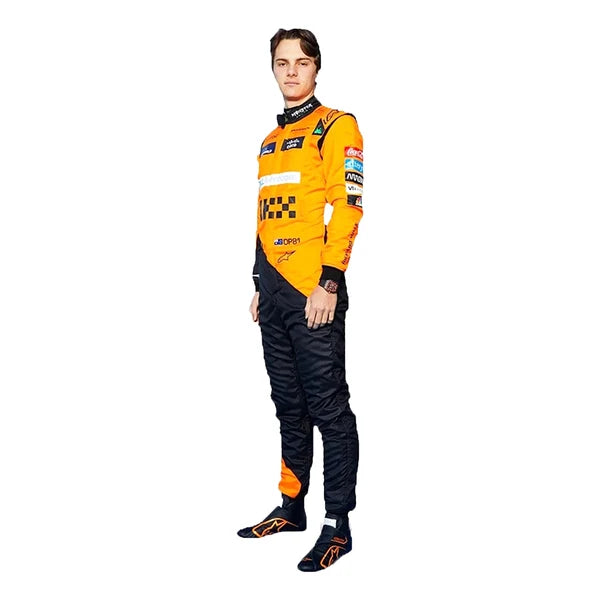2024 Oscar Piastri McLaren F1 Racing Suit Kit featuring papaya orange and dark charcoal race suit, black and orange racing gloves, and low-profile driving shoes